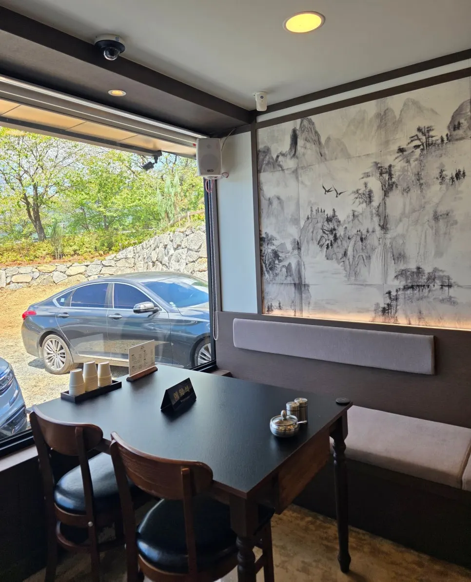 Sangol Chueojeong interior seating lit by floor-to-ceiling windows