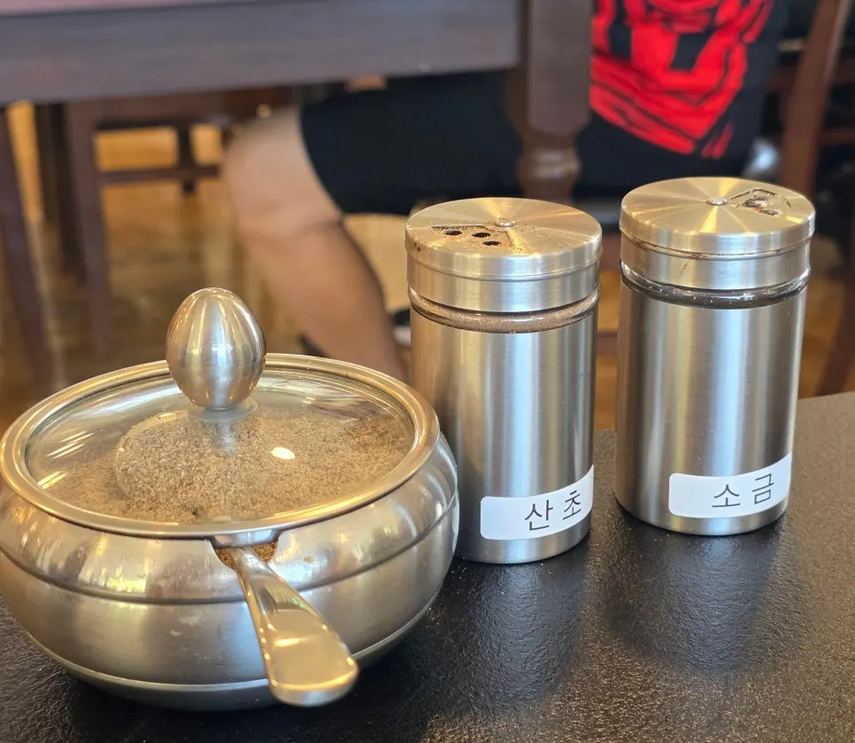 Table setting with perilla powder, sancho pepper, and salt