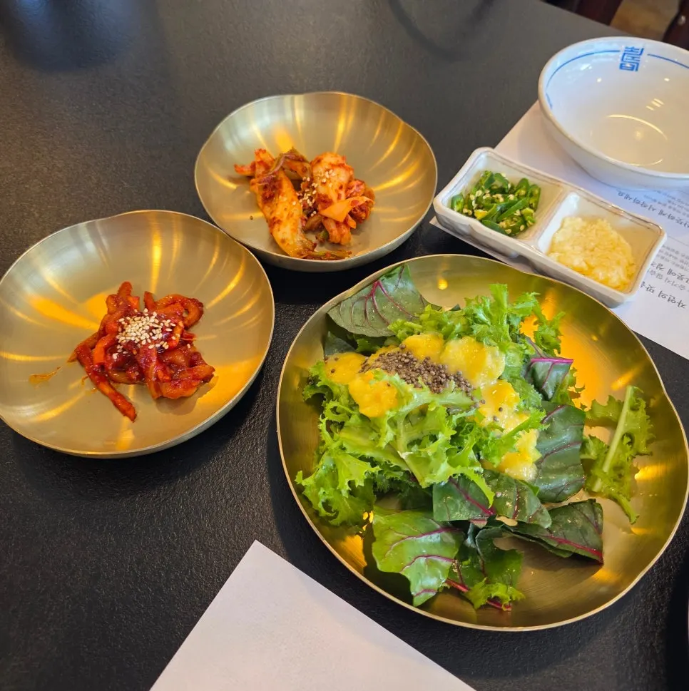 Salted squid, kimchi, and minced garlic side dishes