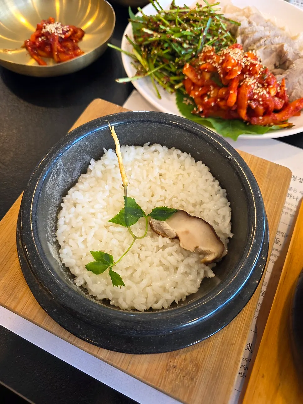 Individual pot rice topped with mushrooms and ginseng sprouts