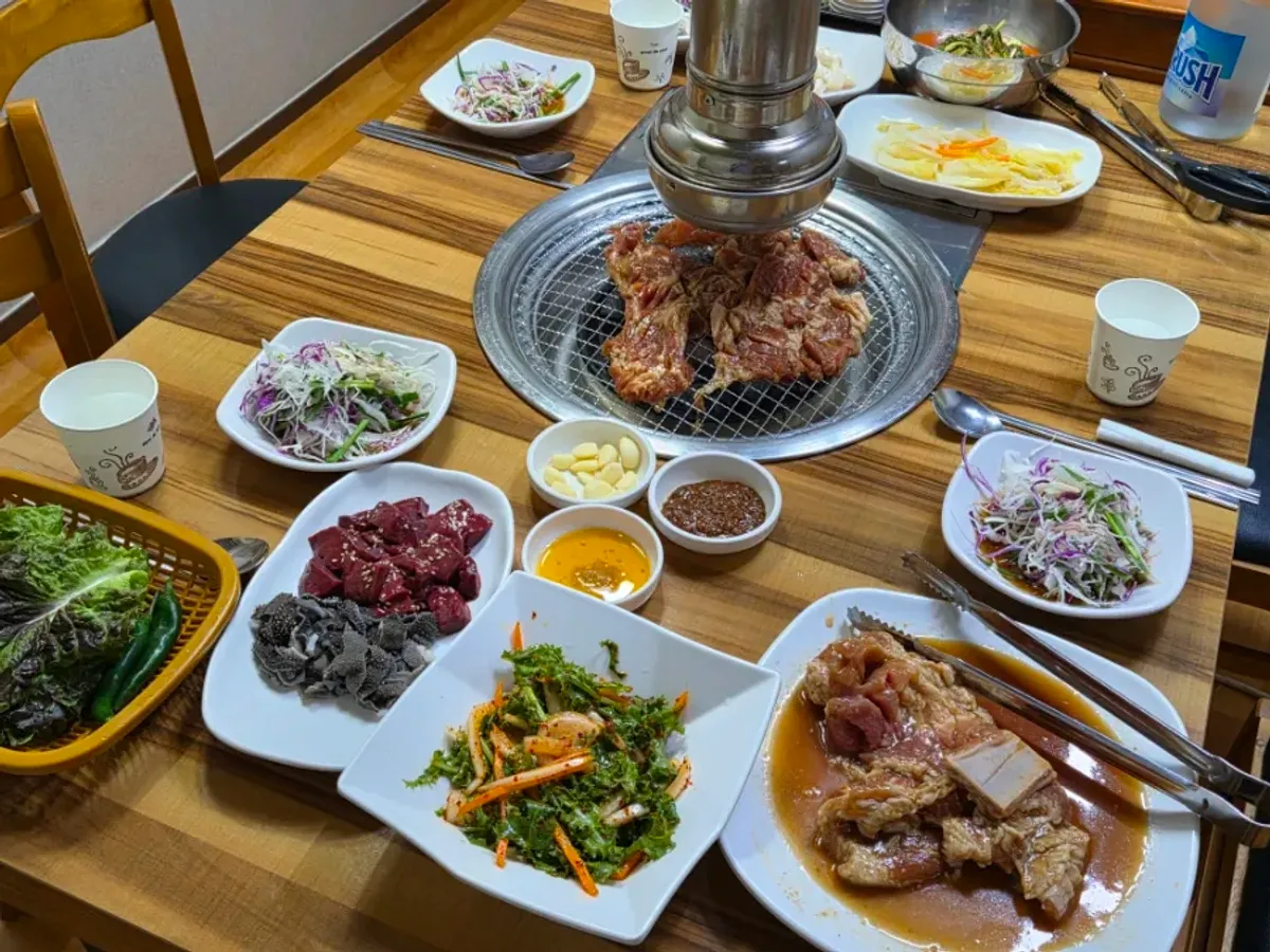 Gochon Soyangan charcoal pork ribs and side dish spread