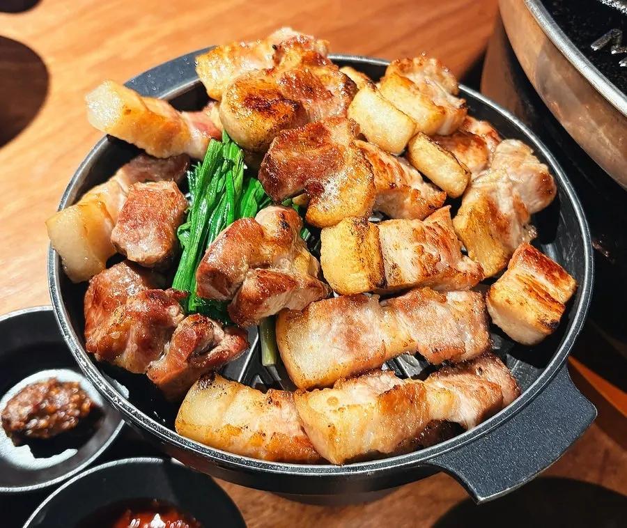 Staff grilling samgyeopsal tableside