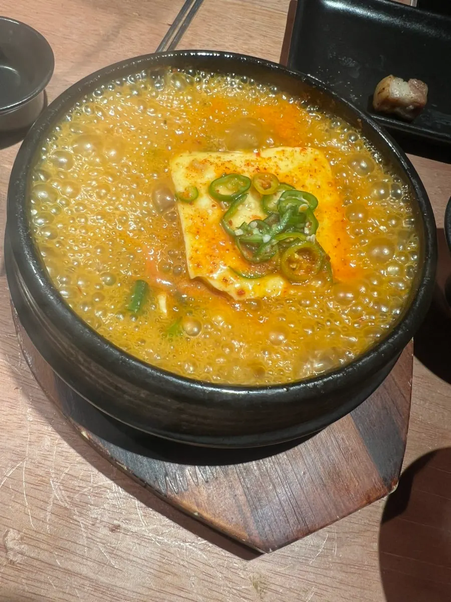 A pot of simmering yeondubu doenjang jjigae