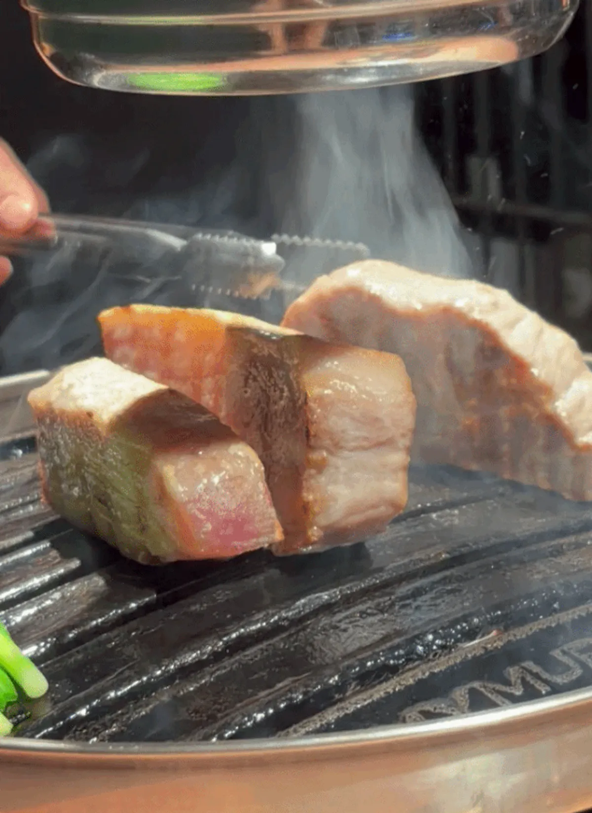 Plate with two servings of cross-aged pork belly and one of pork neck