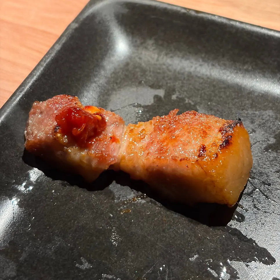 First bite of pork belly dipped in salt