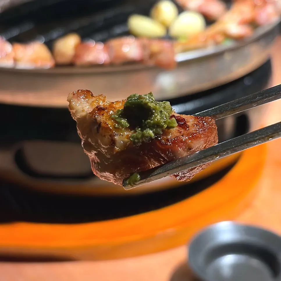 A piece of pork belly topped with squid jeotgal