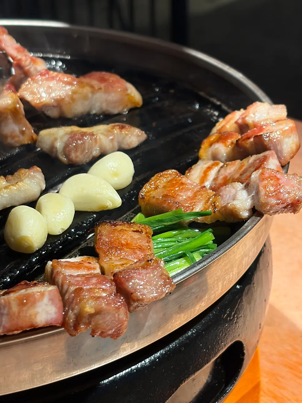 Fully grilled pork belly and pork neck on the grill
