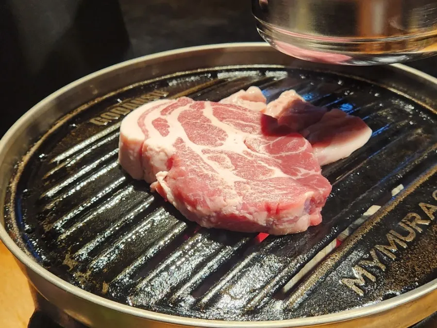Two servings of pork neck served as one thick chunk