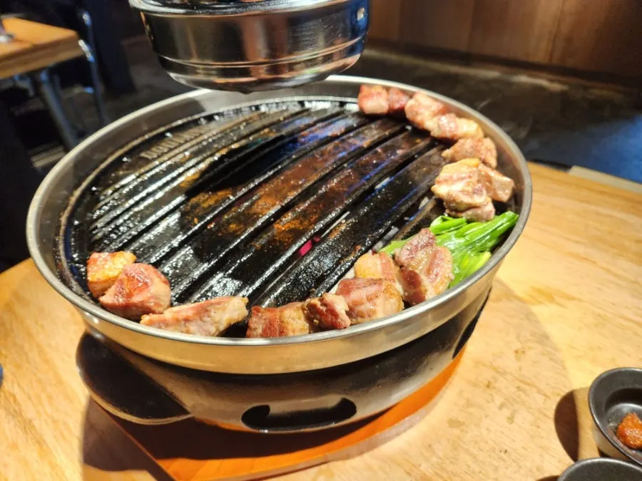 Grilled meat moved to the edge of the grill