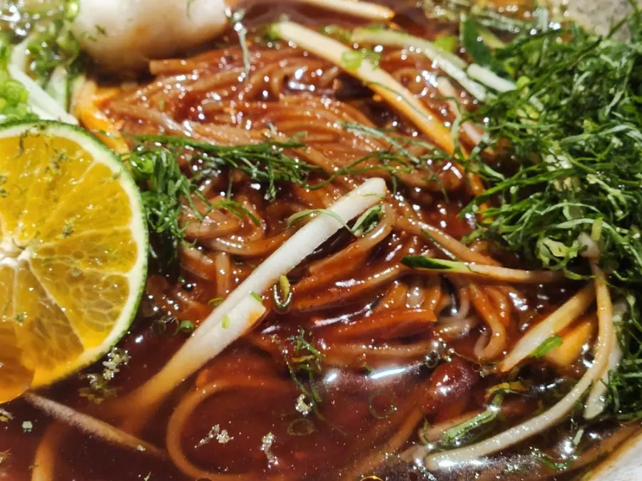 Mul-bibim noodles topped with a mound of vegetables