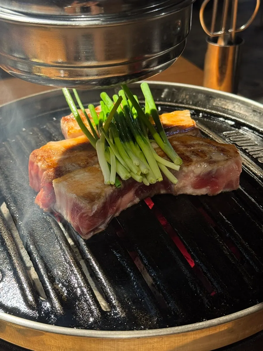 Brazier and hood positioned at the table's edge