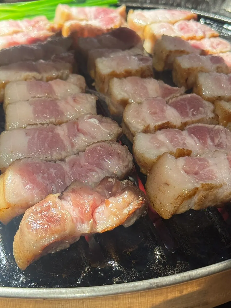 Close-up of pork belly browning nicely