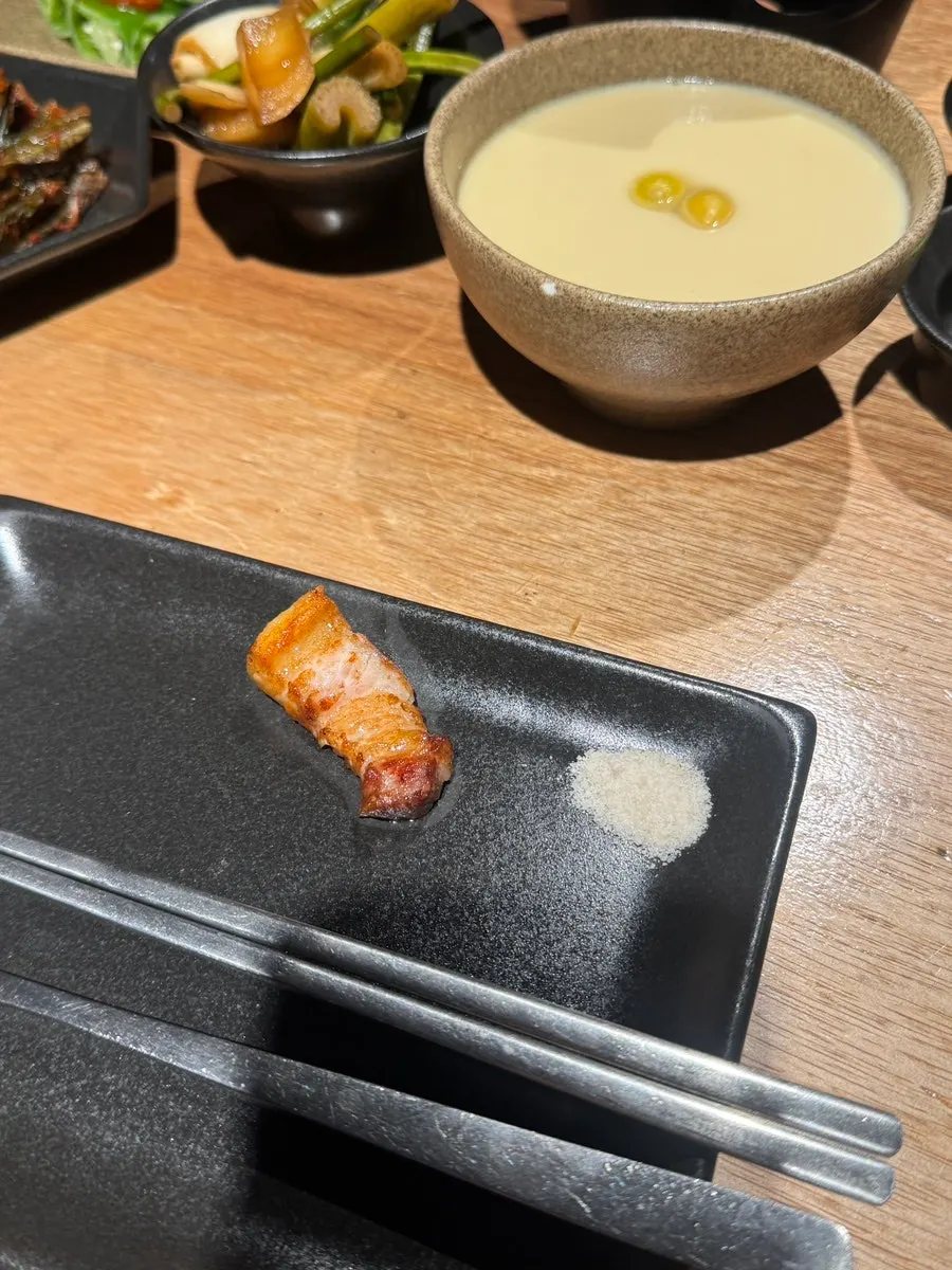 First bite of pork belly dipped in kelp salt