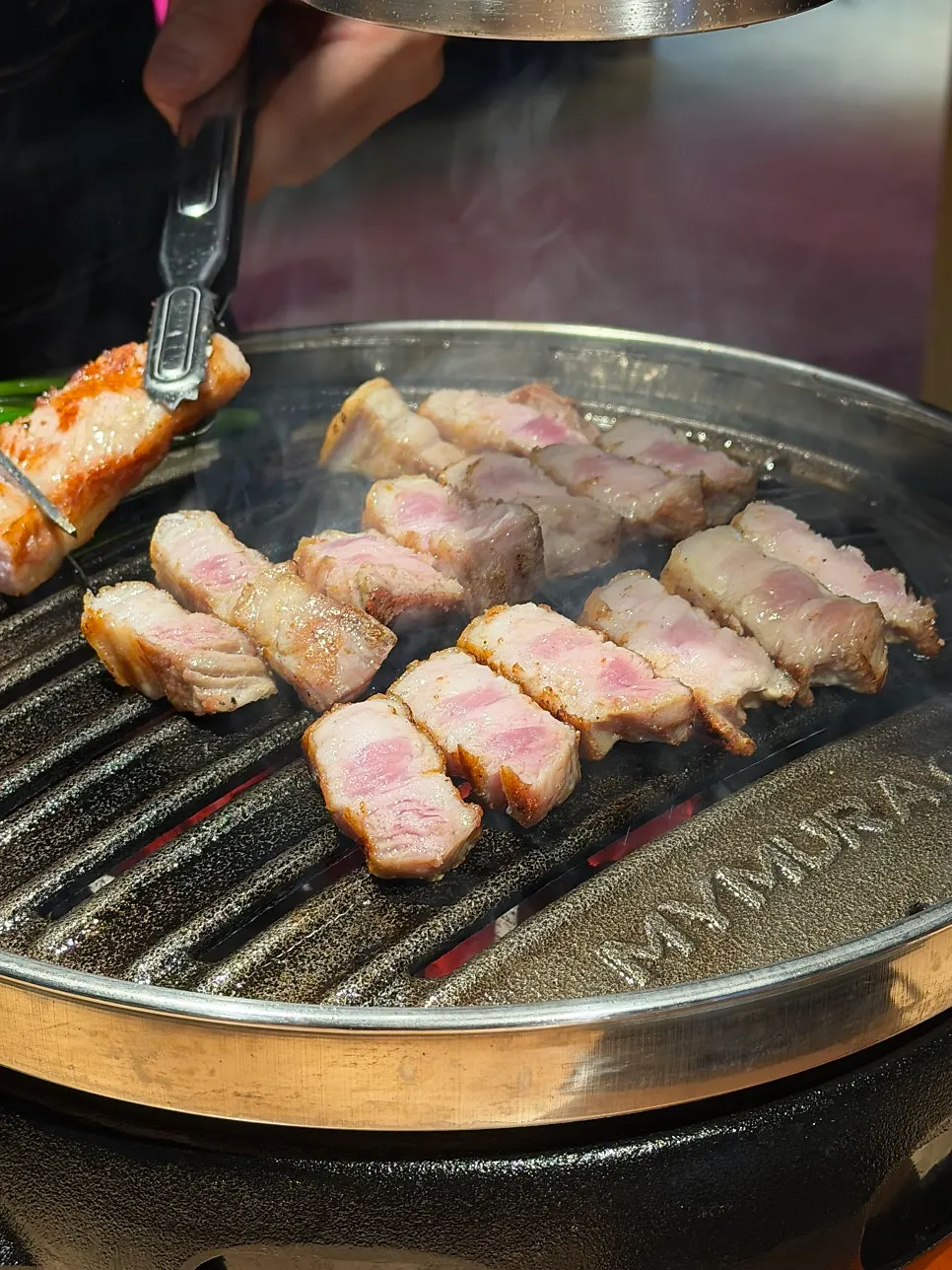 Pork belly and pork jowl on the grill