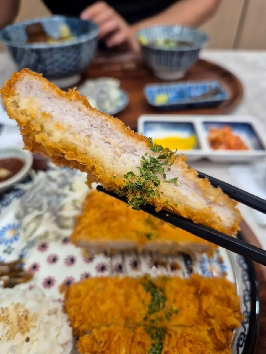 Cross-section of thick handmade pork loin katsu