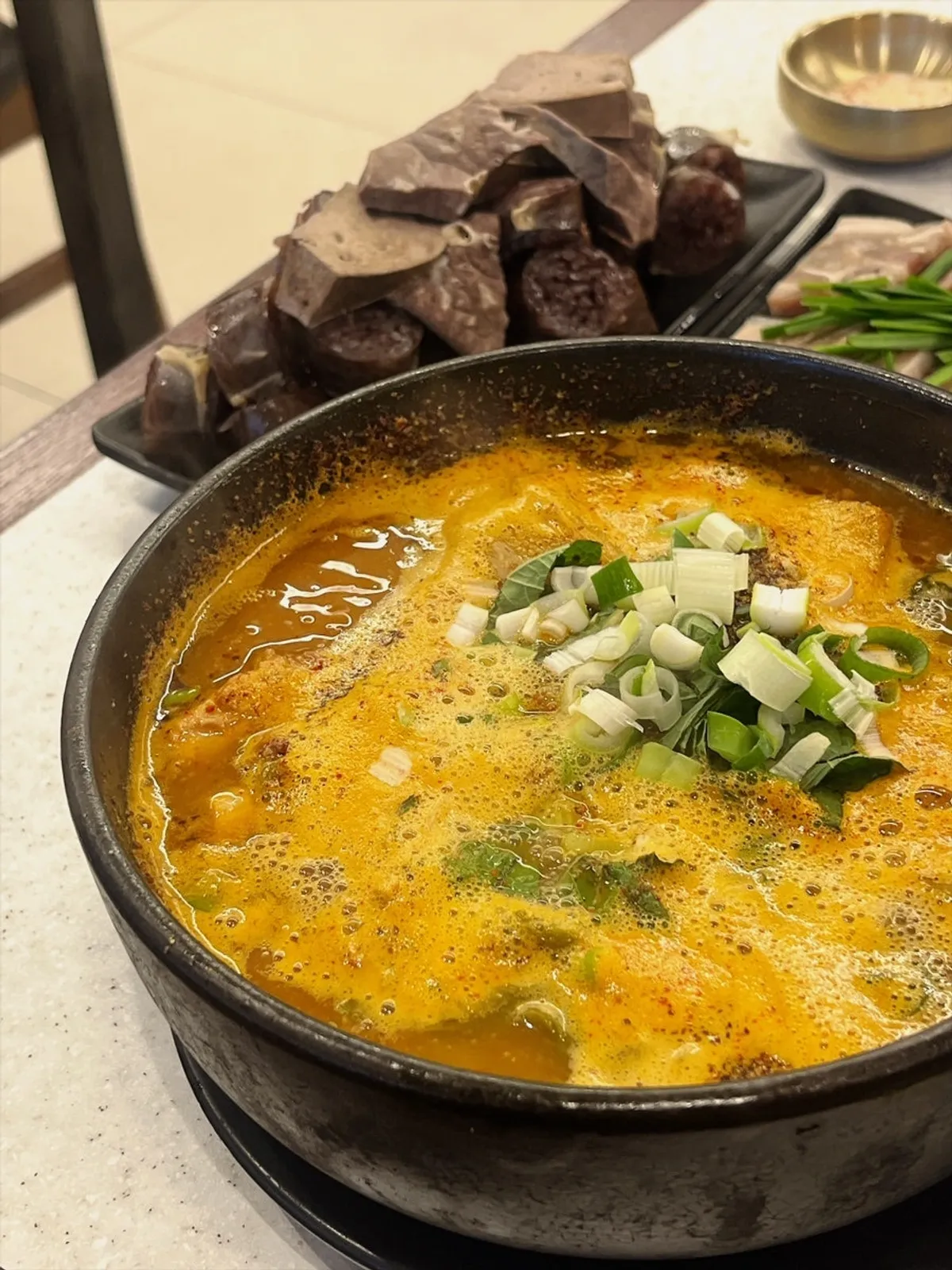 A bowl of ppyeodagwi haejangguk generous with meat