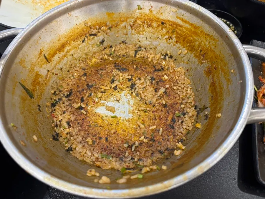 Fried rice being stir-fried as the finishing dish