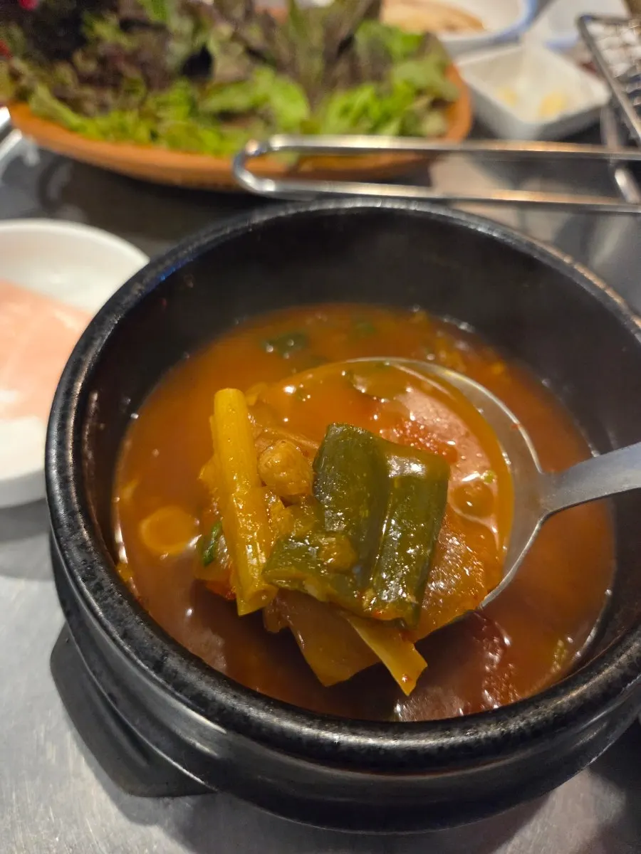 Kimchi jjigae broth with scallions and cheongyang chili