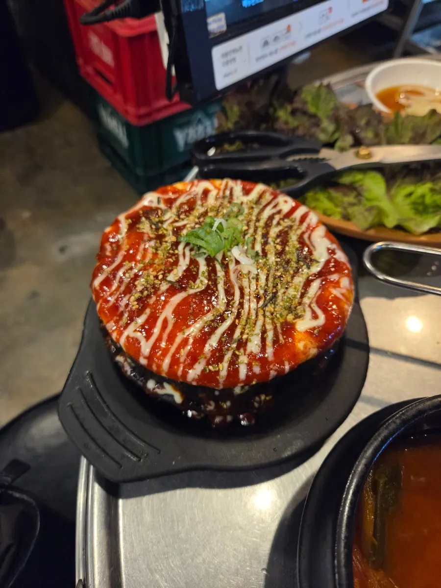 Volcano egg soufflé topped with spicy sauce