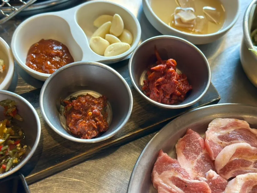 Pickled kimchi and pickled chili strips among the side dishes