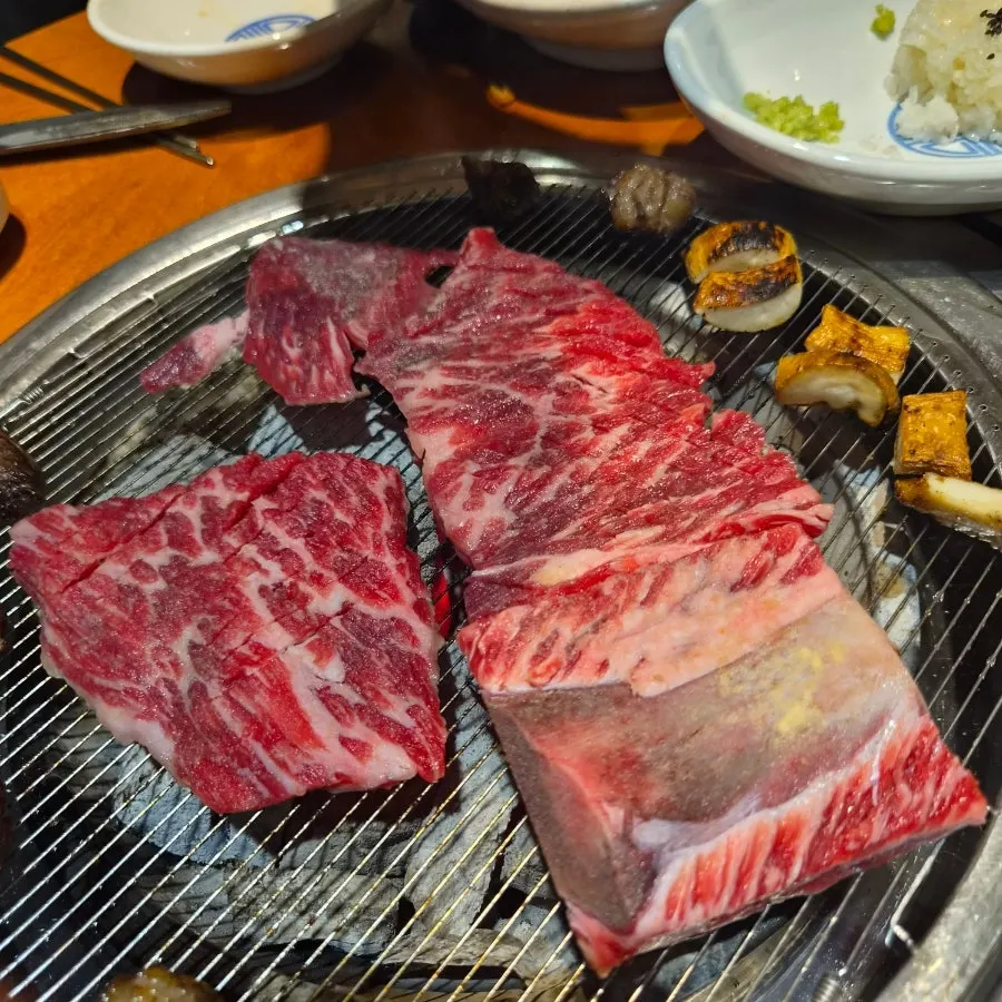 A piece of grilled beef placed on top of sushi