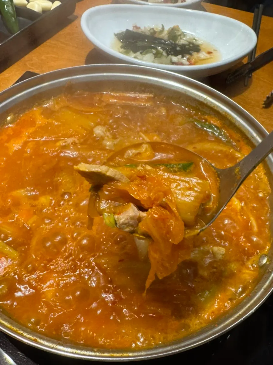 Pork kimchi stew topped with minced garlic