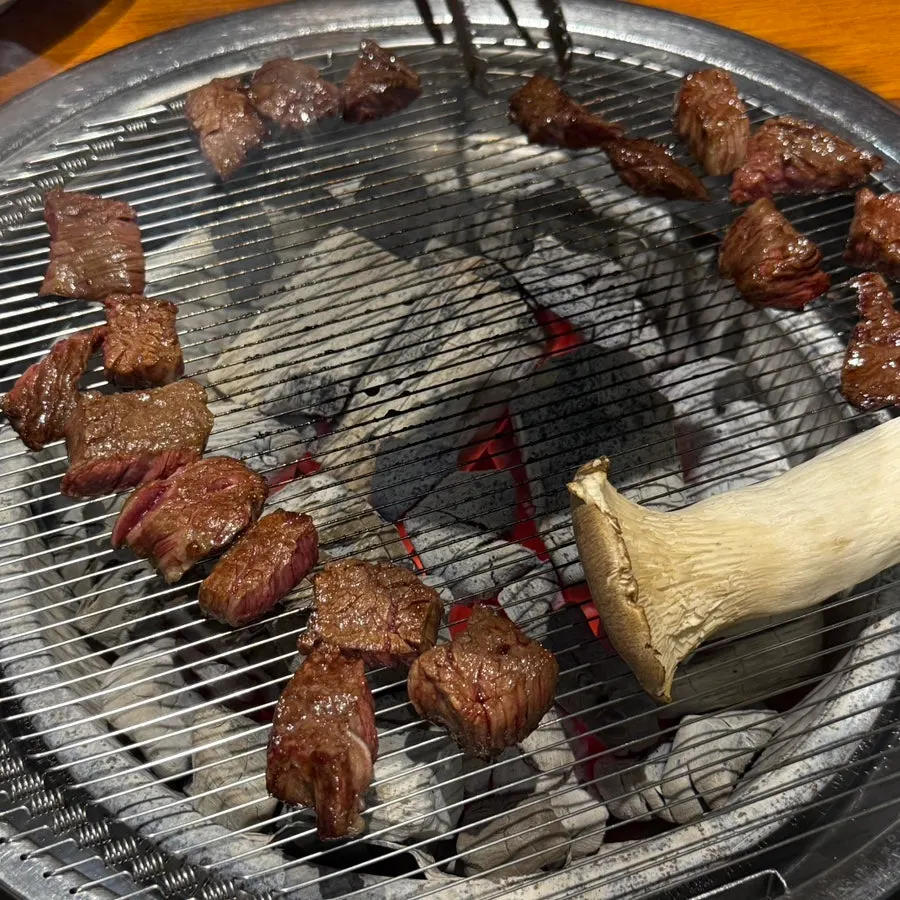 Skirt steak cooking over charcoal