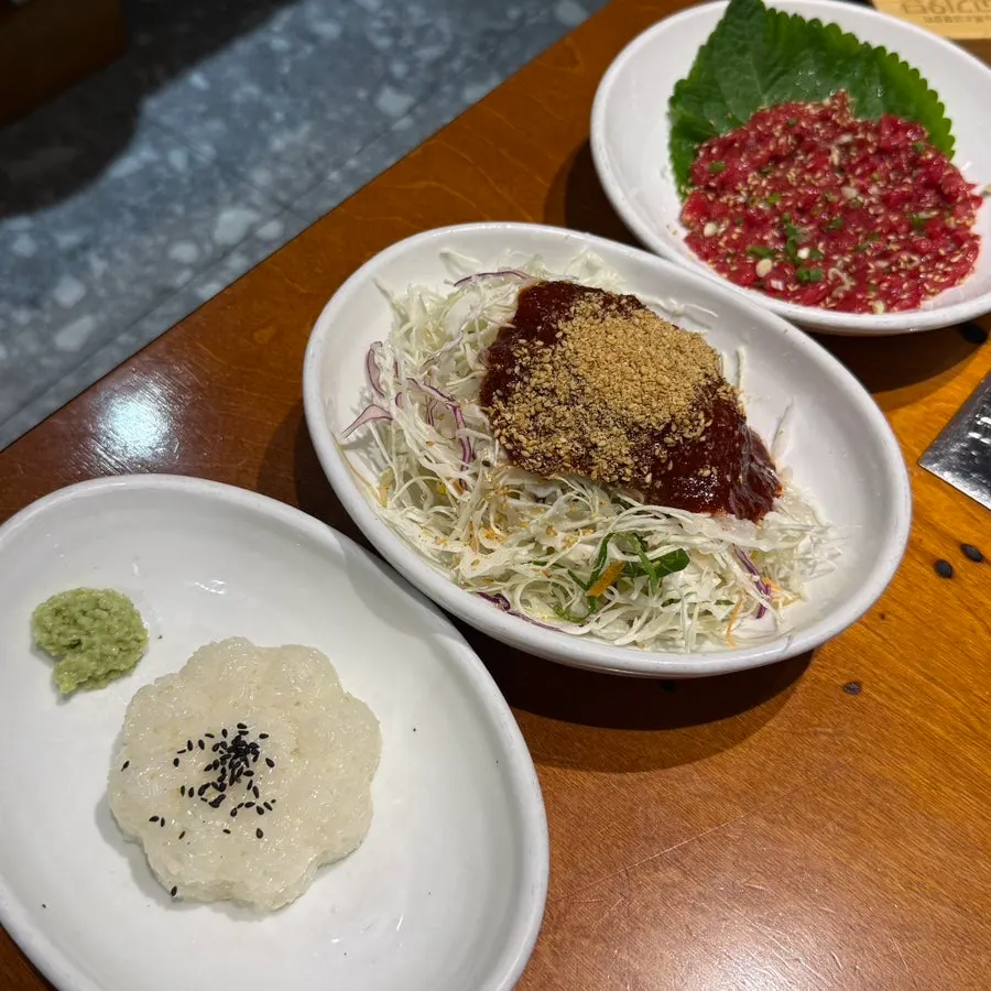 9dan set spread with raw beef tartare, stew, jjolmyeon noodles, and sushi