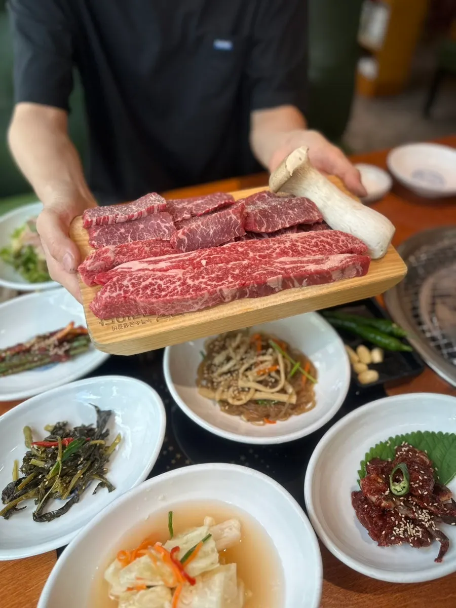 Table spread of banchan including yangnyeom gejang and japchae