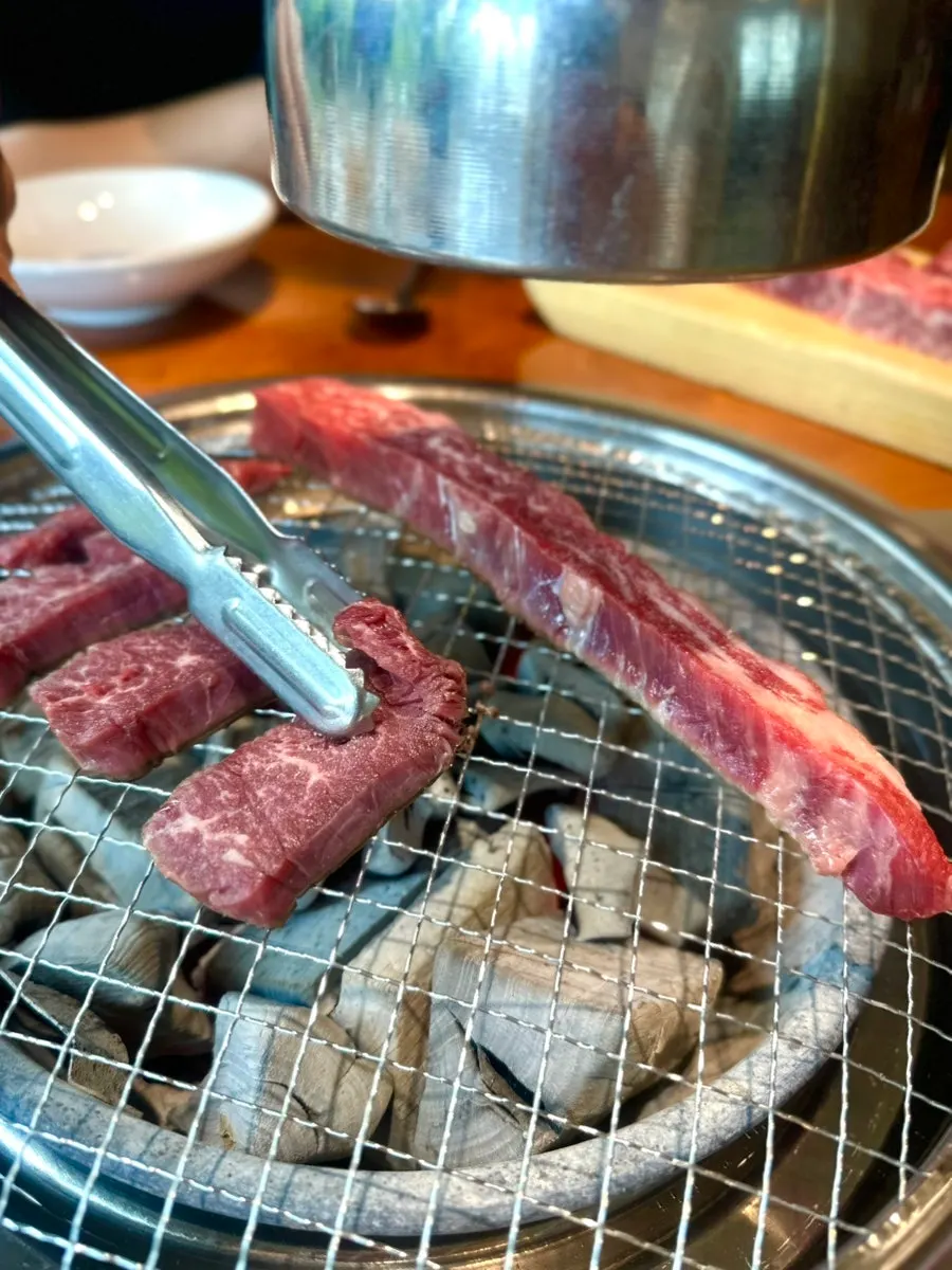 Two plates of beef set by the window