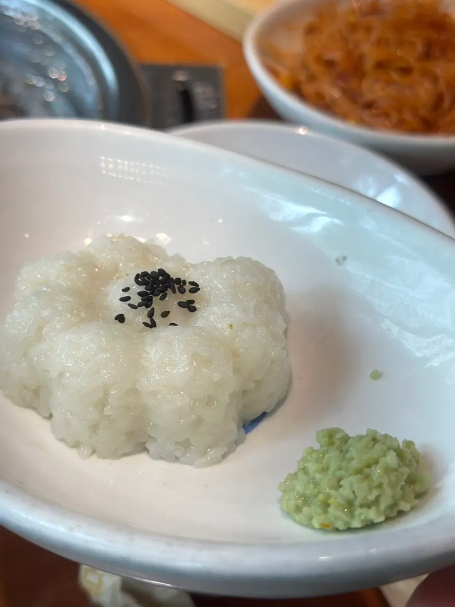 Spicy jjolmyeon topped with bean sprouts