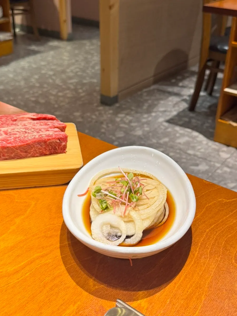 Basic table setting including japchae and spicy seasoned crab