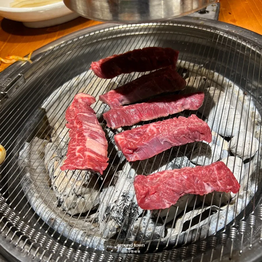 Skirt steak grilling over charcoal