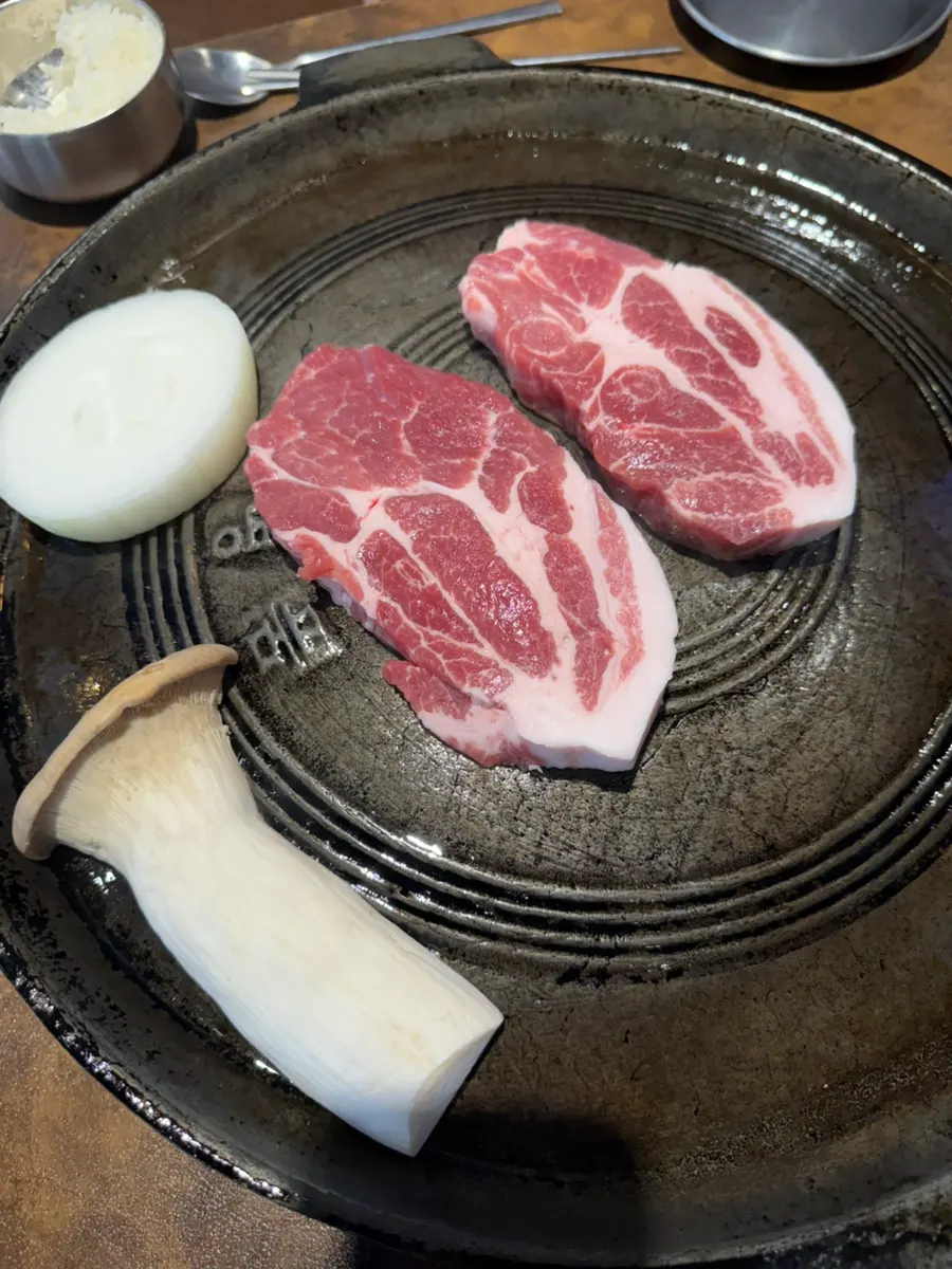 Two servings of thickly sliced raw premium pork neck
