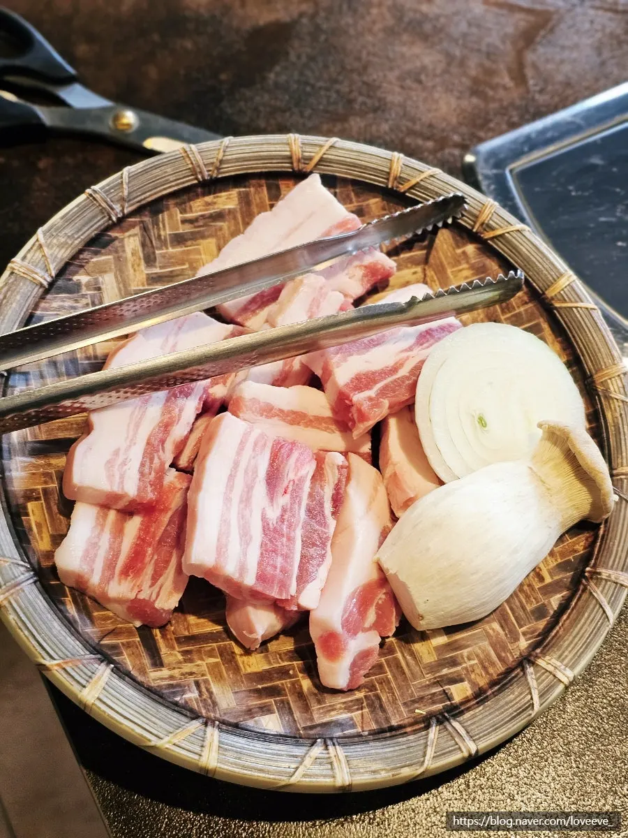Two servings of raw pork belly with onion and king oyster mushrooms