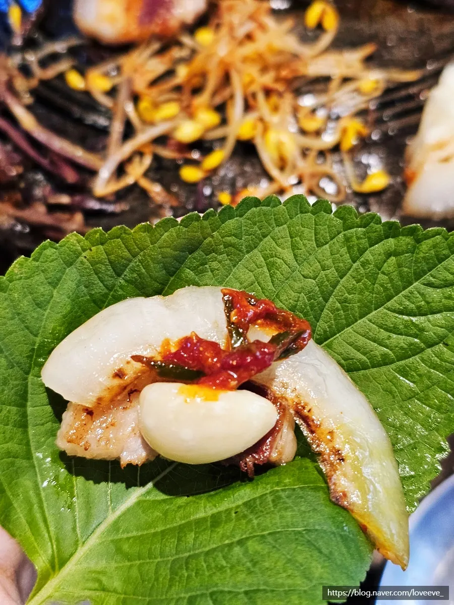 A pork belly lettuce wrap loaded with vegetables