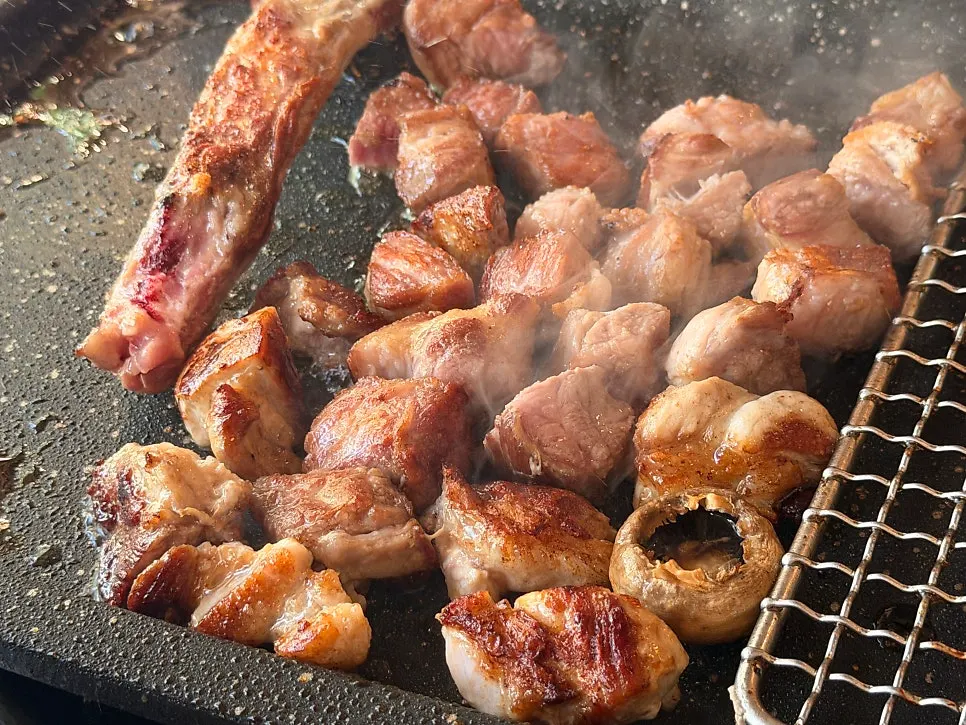Staff grilling meat on the plate