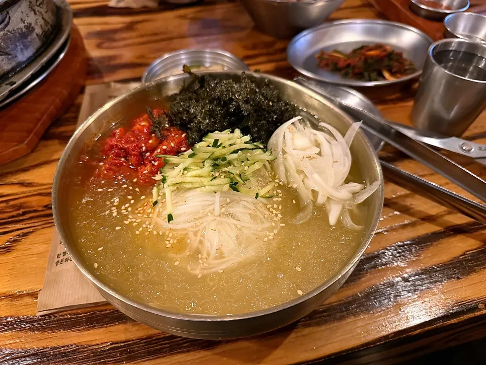 Chilled kimchi mari guksu served at the table