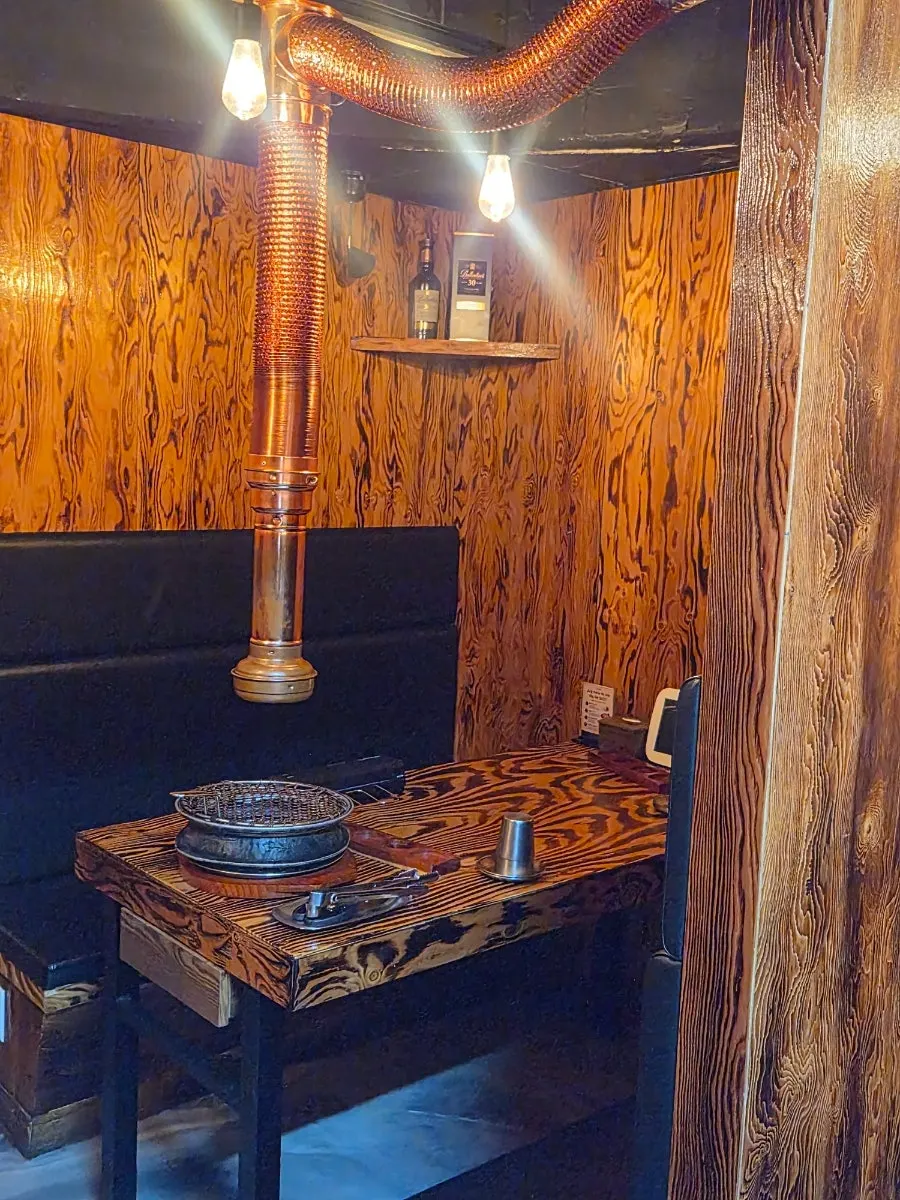 3rd floor hall with dark tones and wood and gold accents