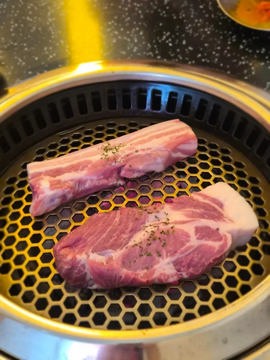 Table spread of thick-cut raw pork belly and pork neck