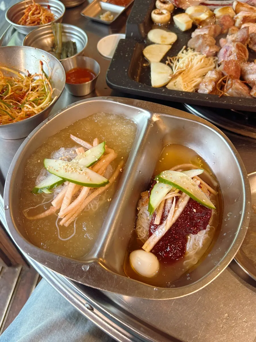 Kimchi and minari grilled on one side of the grill