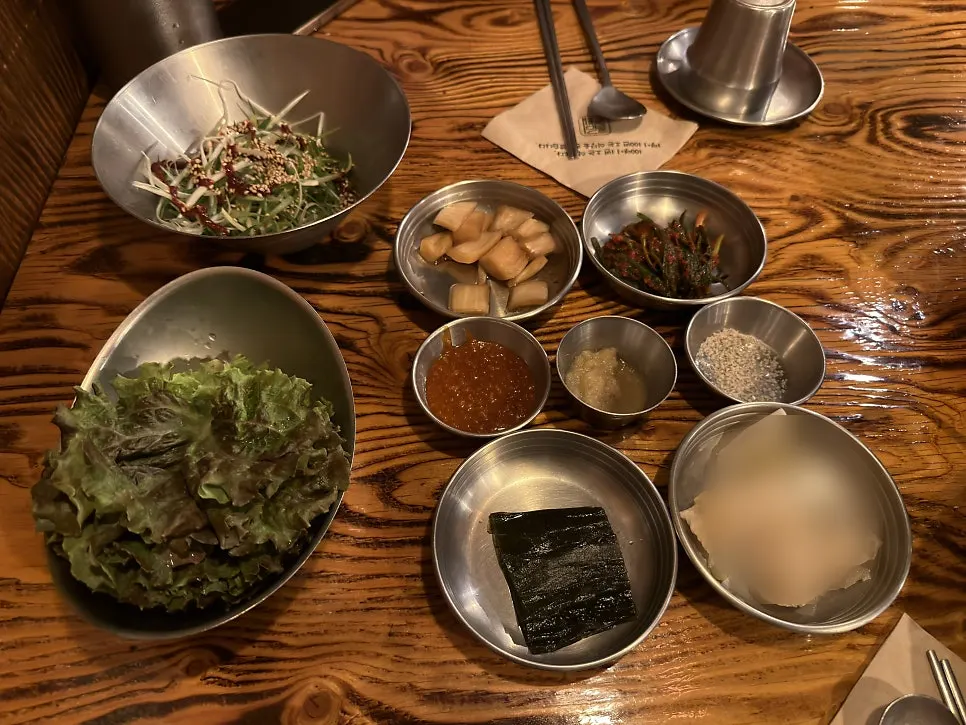 Side dishes including scallion salad and myeongi namul