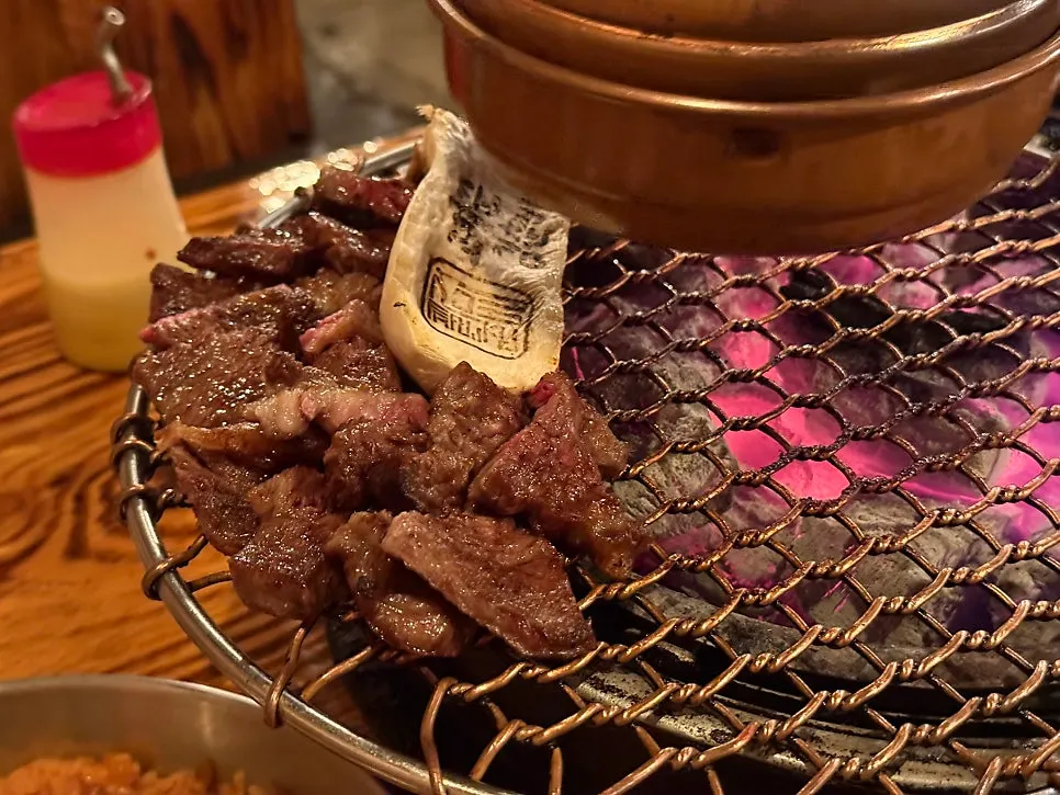 Fully grilled beef moved to the edge of the grill