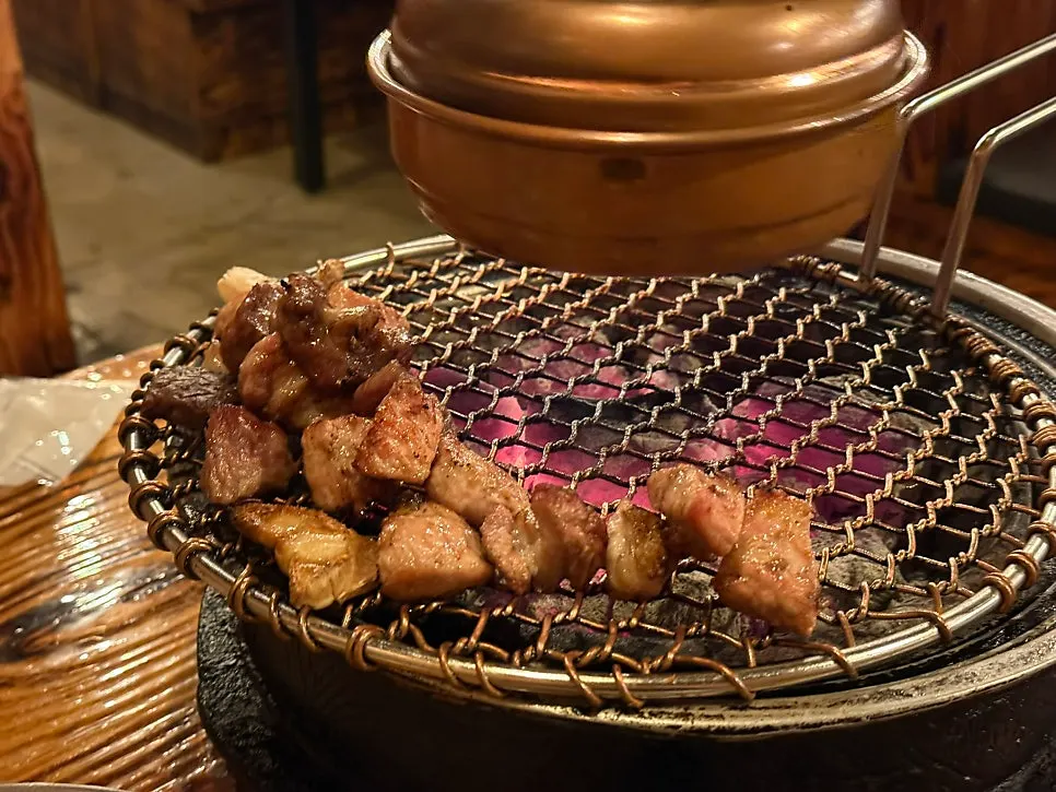 Fresh galbisal grilling over the charcoal fire