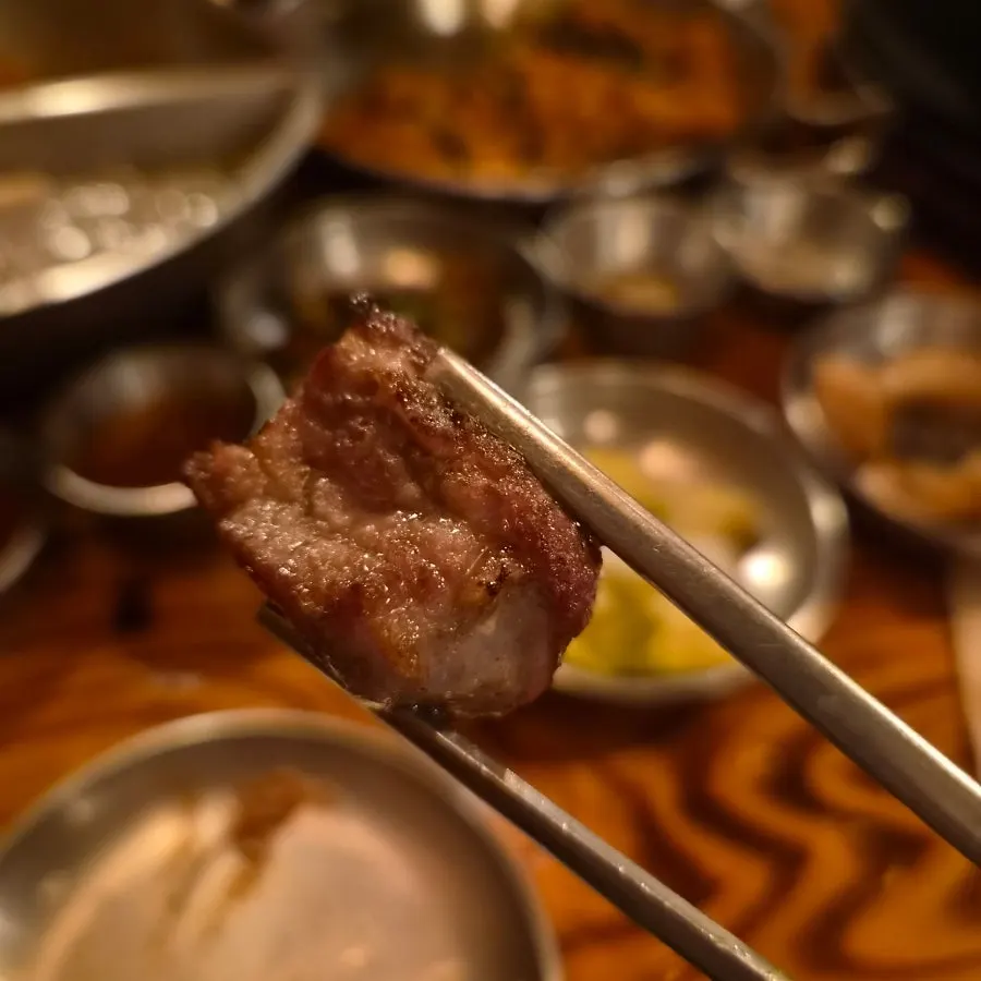 Fully cooked raw galbisal pulled to the front of the pan