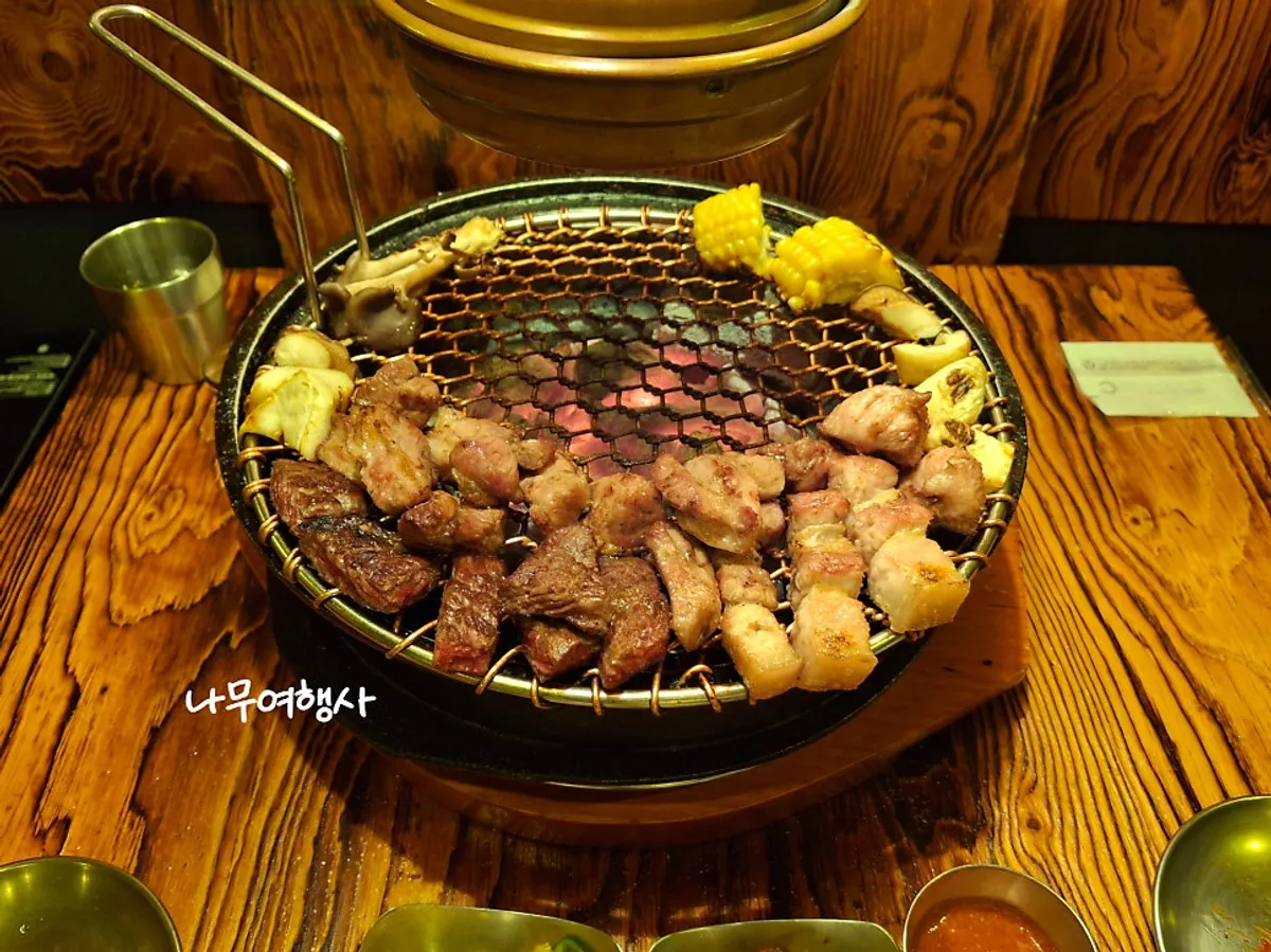 Grilled meat over the charcoal grill at Jonggak-ap Nosang Gongyeong Juchajang
