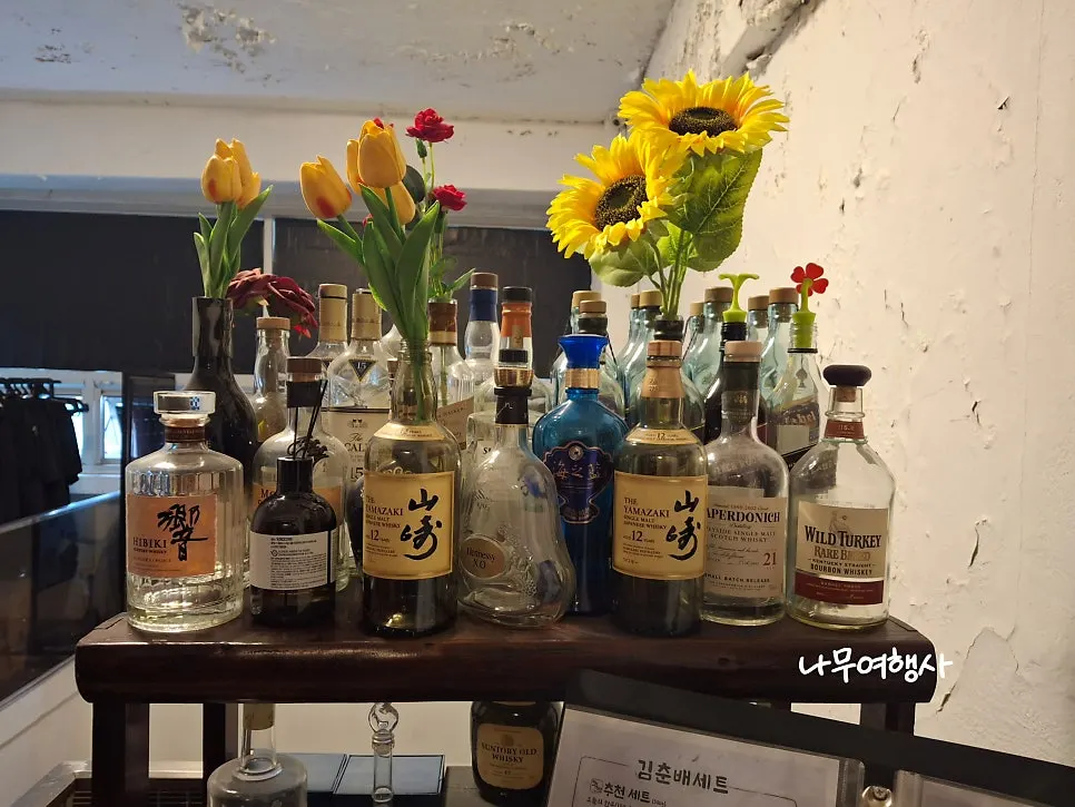 Empty liquor bottles lined up outside the restaurant entrance