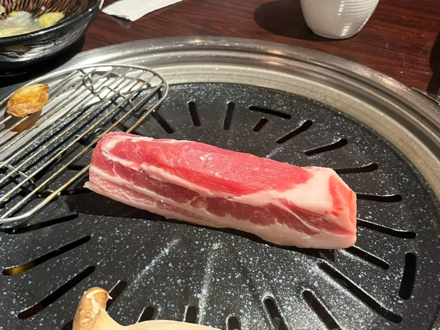 Extra serving of raw fresh pork belly on a plate