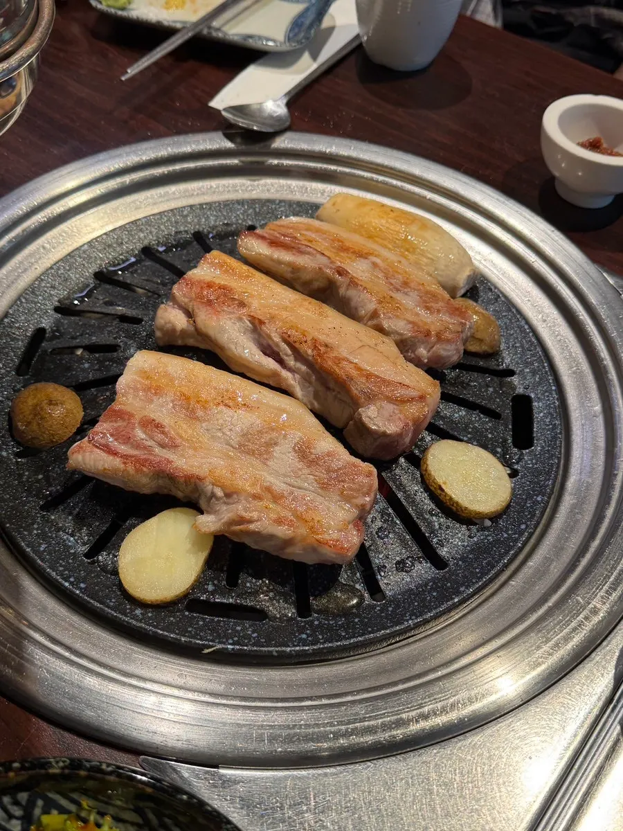 Pork belly grilling on the tabletop grill