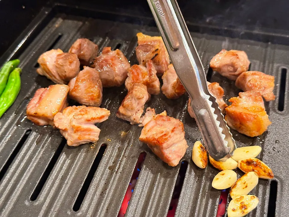 Pork neck grilling on the griddle